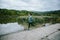 Man at the lake running against green cloudy nature