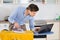 Man With Laptop While Ironing Cloth