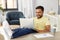 Man with laptop resting feet on table at home