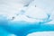 Man on a large ice fin surrounded by glacial pool on the Matanuska Glacier in Alaska