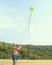 The man is launching a big kite snake over blue sky