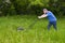 Man with Lawnmower Mowing Tall Grass and Big, Large Lawn