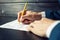 Man lawyer or official signs documents with a pen