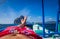 Man laying in banca boat, feet facing Inabuyatan Island by El-Nido, Palawan, Philippines