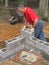 Man laying concrete block wall