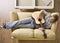 Man laying on sofa playing guitar