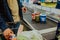 man lays out groceries from supermarket basket on conveyor belt. Shopping foods, cash register in store.