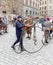 Man leading an very old bicycle and wearing old fashioned tweed