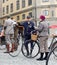 Man leading an very old bicycle and wearing old fashioned tweed