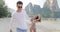 Man Leading Woman Couple Walking On Beach Holding Hands Talking Young Tourists On Vacation
