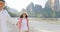 Man Leading Woman Couple Walking On Beach Holding Hands Talking Young Tourists On Vacation