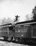 Man leaping across the roof of railroad cars