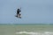 Man learning basic jumps kitesurfing, boy jumping at kiteboarding school. Kite surf lessons in the Canary islands, Fuerteventura