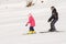 A man learns to ski teenage girl on a snow-covered slope ski resort Dombai