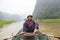 Man leg rowing along Ngo River