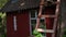 Man legs climbing on high wooden ladder outdoor