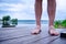 Man legs standing on a dock while relaxing on seaside.