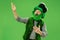 A man in a leprechaun hat at studio. He celebrates St. Patrick`s Day.