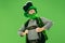 A man in a leprechaun hat at studio. He celebrates St. Patrick`s Day.