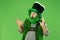 A man in a leprechaun hat at studio. He celebrates St. Patrick`s Day.