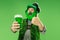 A man in a leprechaun hat at studio. He celebrates St. Patrick`s Day.