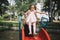 Man lifting little girl over slider in playground