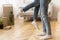 Man Lifting Wife Standing Among Boxes In New Flat, Cropped