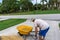 Man lifts wheelbarrow full of gravel