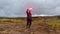 A man lights a signal fire in a field. Trekking in the Klyucheskiy park of volcanoes.