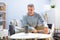 Man Listening To Wireless Speaker On Furniture