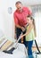 Man and little girl hoovering at home