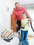 Man and little girl vacuuming at home