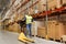 Man with loader and clipboard at warehouse