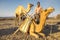 Man loading his camels at the Erta Ale base camp for the night`s trek up to the volcano.