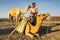 Man loading his camels at the Erta Ale base camp for the night`s trek up to the volcano.