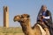 Man in local head dress and clothes riding a camel, Sanliurfa, Turkey