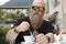 a man with long beard, drinking, enjoys a cup of coffee, Cappucino