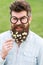 Man with long beard and mustache, defocused green background. Hipster with beard on cheerful face, posing with glasses