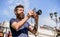 Man with long beard shooting photos. Manual settings. Photographer hold vintage camera. Modern blogger. Content creator