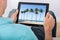 Man looking at beach photo on tablet