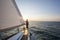 Man Looking At Beautiful Sea From Bow Of Sail Boat