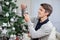Man Looking At Bell While Decorating Christmas