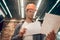 Man looking at construction drawings in lighted room