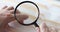 Man looking for documents in folders using magnifying glass closeup 4k movie slow motio