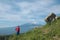 Man looking at Etna Mount and cirrus clouds against blue sky