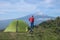 Man looking at Etna Mount near the green tent