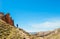 Man looking far on hillside in Binggou Danxia Scenic Area