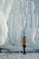 Man Looking on a Giant Icicles on a Frozen Coast Lake Baikal, Russia