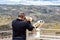 Man looking through high powered binoculars on a scenic mountain lookout. Sierras de Francia and of Bejar. UNESCO World Heritage