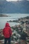 Man looking at Kotor bay and town in the rain